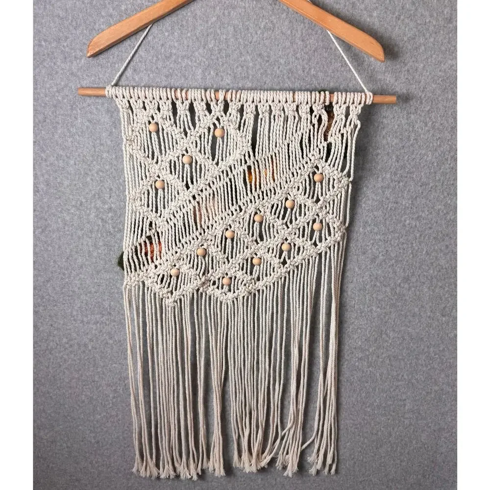 handmade boho-style macramé wall hanging crocheted flowers wooden beads fringe